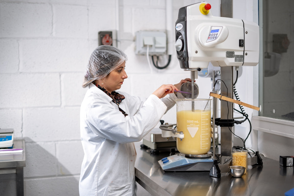 a person in a white coat working in a lab