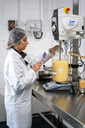 a man in a white coat working in a lab